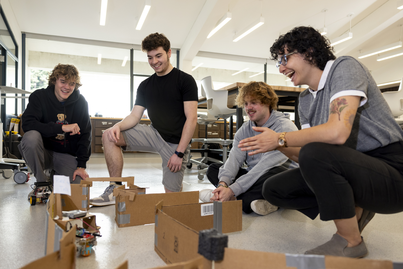 Students watching their self-driving robot run.