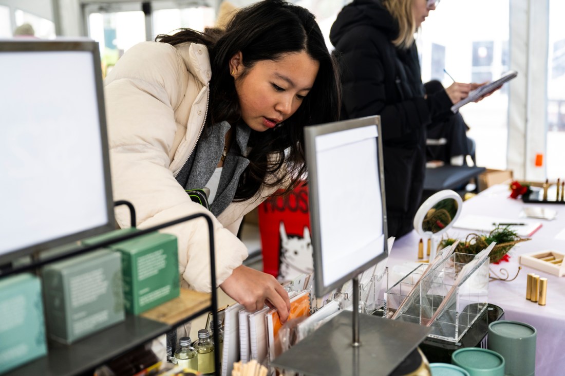 Member of the Northeastern community looking through goods for sale.