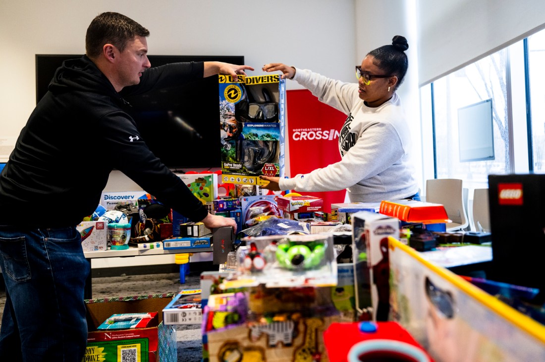 Ashanti Brown handing a package to Michael Fitzgerald.