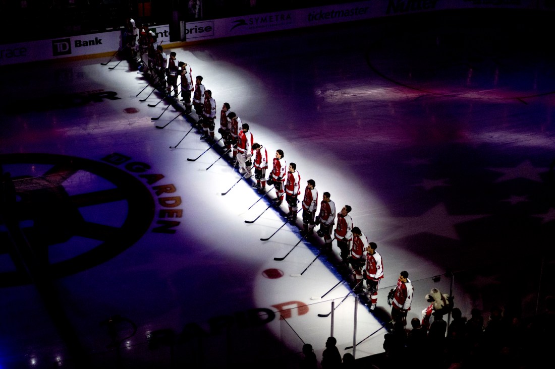 Mens hockey team in line on the ice for the 2023 Beanpot game at TD Garden.
