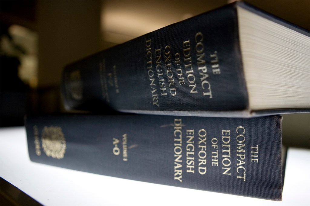 Two Oxford English dictionaries with black covers stacked on top of each other.