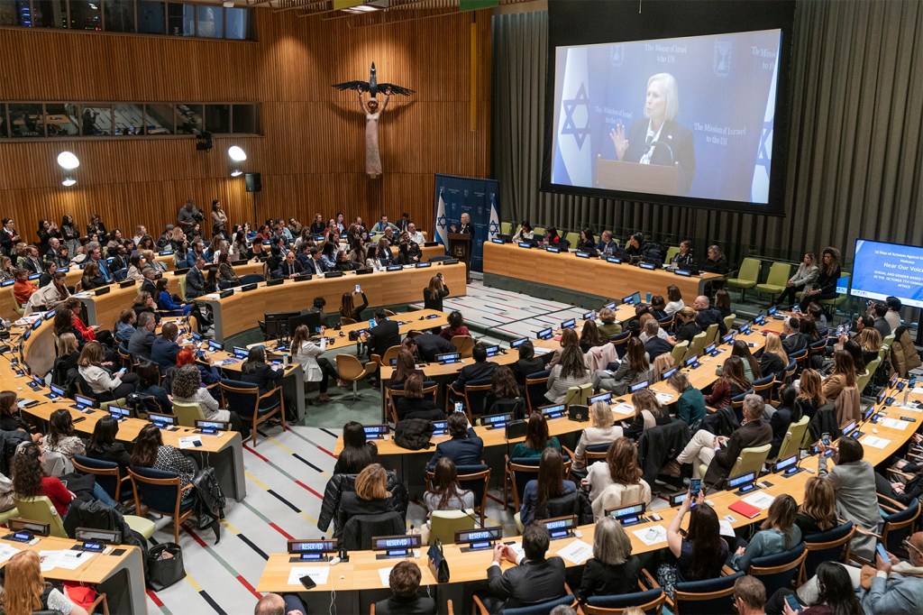 Audience members setting in at an event at the UN Headquarters listening to Senator Kirsten Gillibrand speaking.