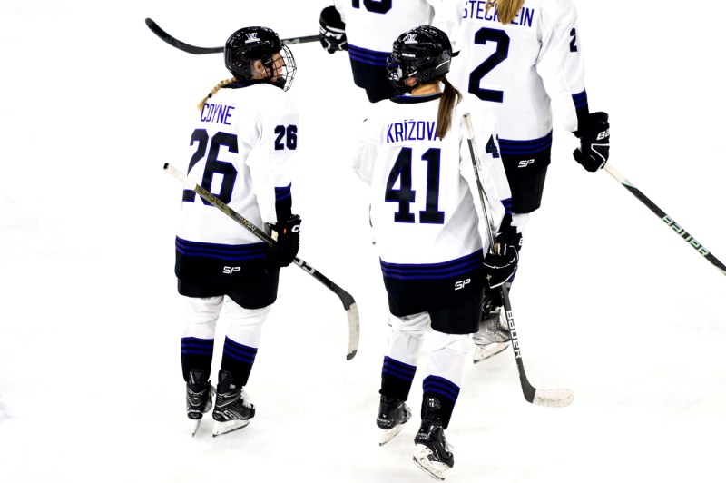Kendall Coyne Schofield and Denisa Krisova skating on ice. 