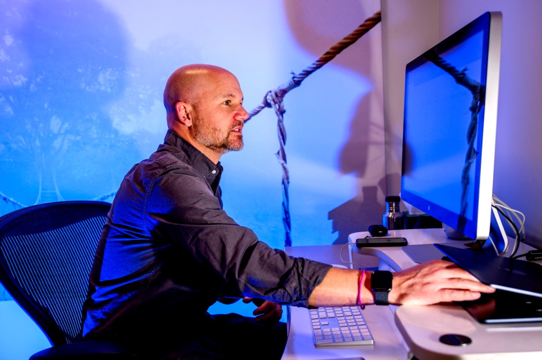 Matthew Goodwin sits at a computer monitoring results.