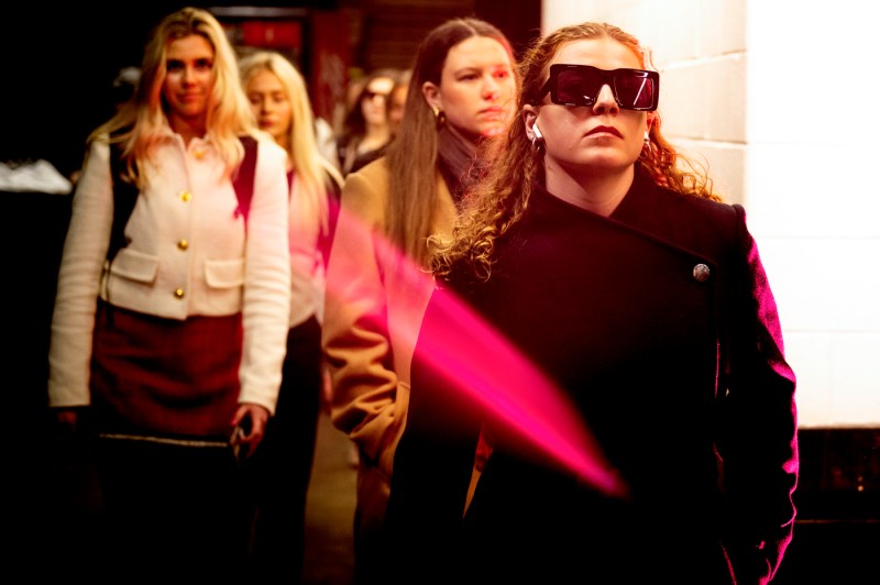 Northeastern women's hockey team memberes walk in TD garden wearing street clothing. 