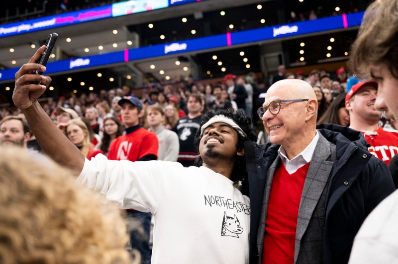 A member of the Northeastern community takes a selfie with President Aoun.