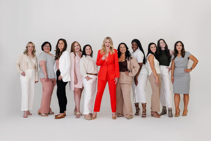 A group of women posing in a photo studio.