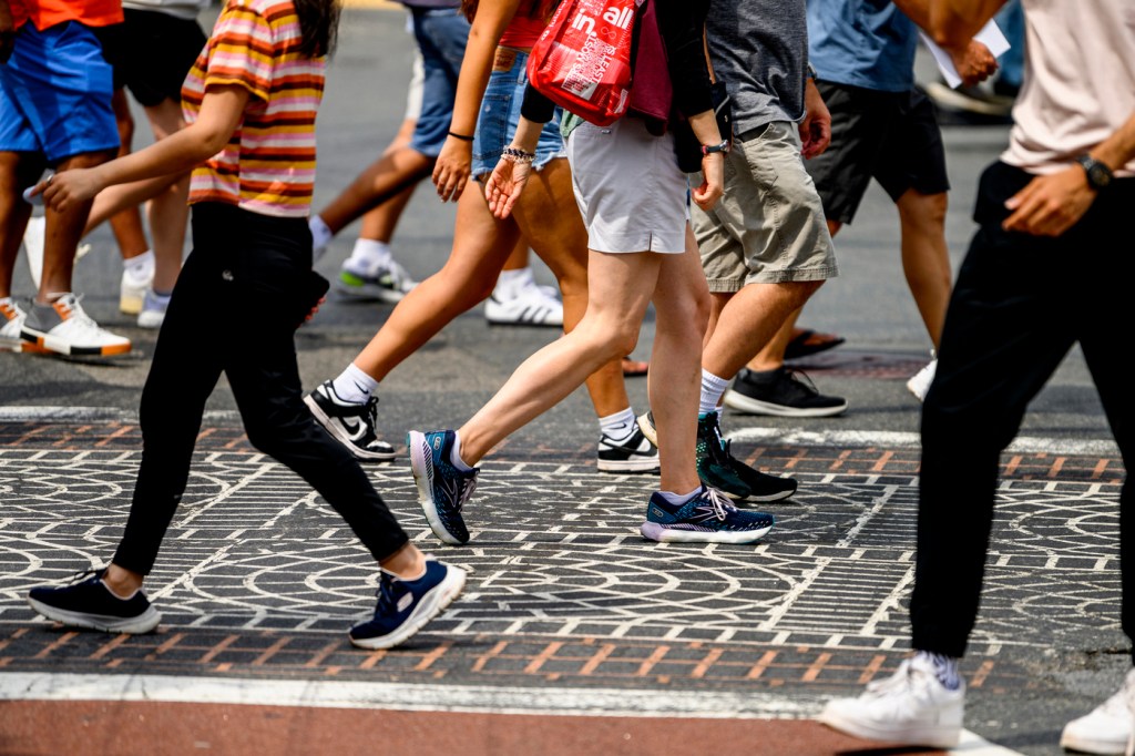 A crowd of pedestrians crossing a street.