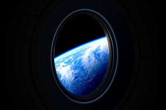 View of planet earth from the porthole of a spacecraft in space.