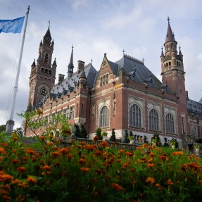 A palace displayed in the sunlight on a cloudy day.