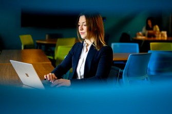 Alexa LaRue sitting in front of her laptop.