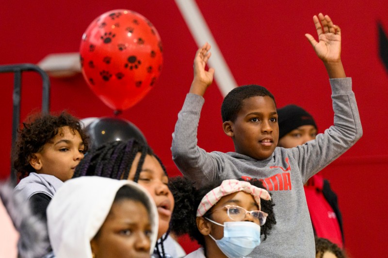 Kids standing with their hands in the air.