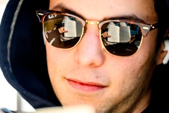 A close-up image of a person wearing glasses, with the lenses reflecting the pages of a book.