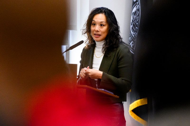 Tiffany Chu, Chief of Staff to Mayor Michelle Wu, City of Boston, speaks at a podium in front of an audience about the benefits of Boston's youth employment program.