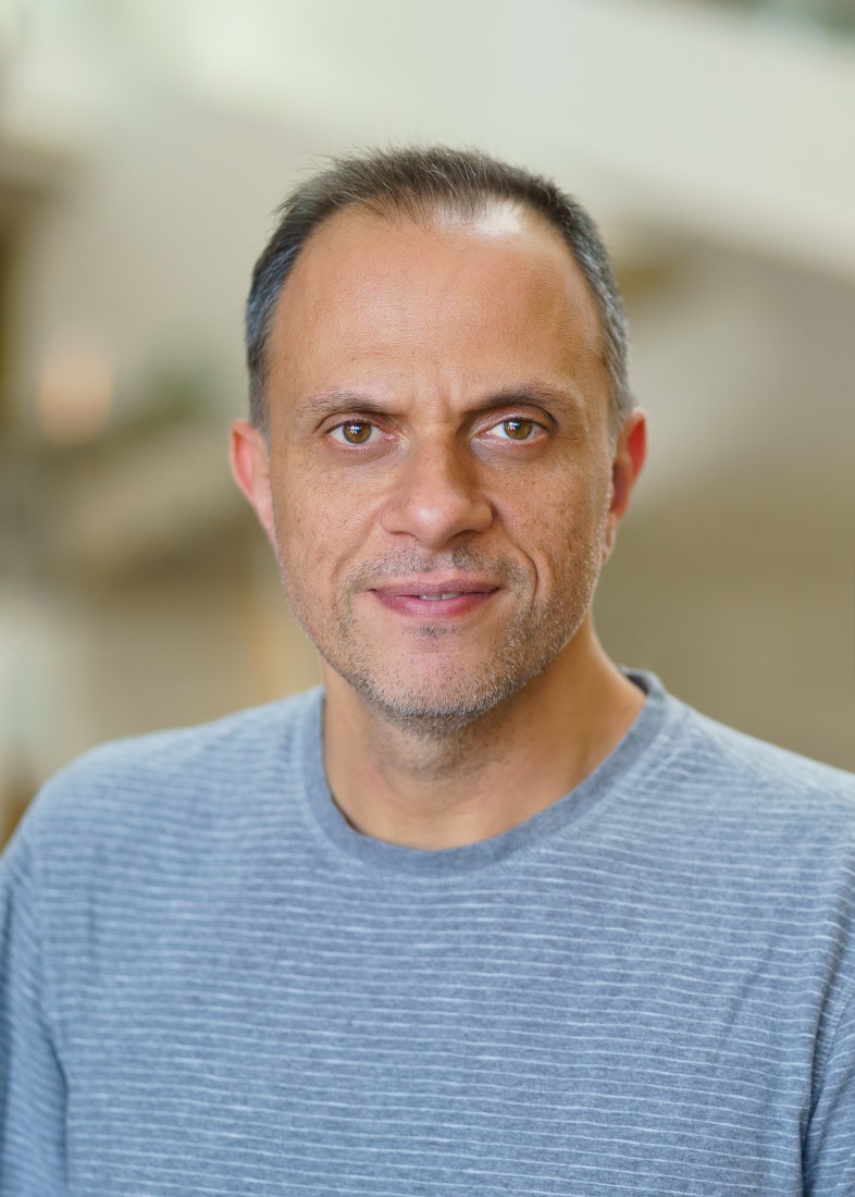 Professor Meni Wanunu stands before a blurred background.