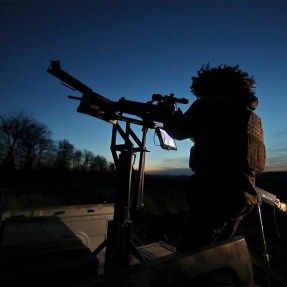 A serviceman on combat duty at dusk.