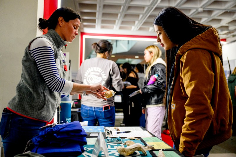 High school students looking at specimens at a symposium.