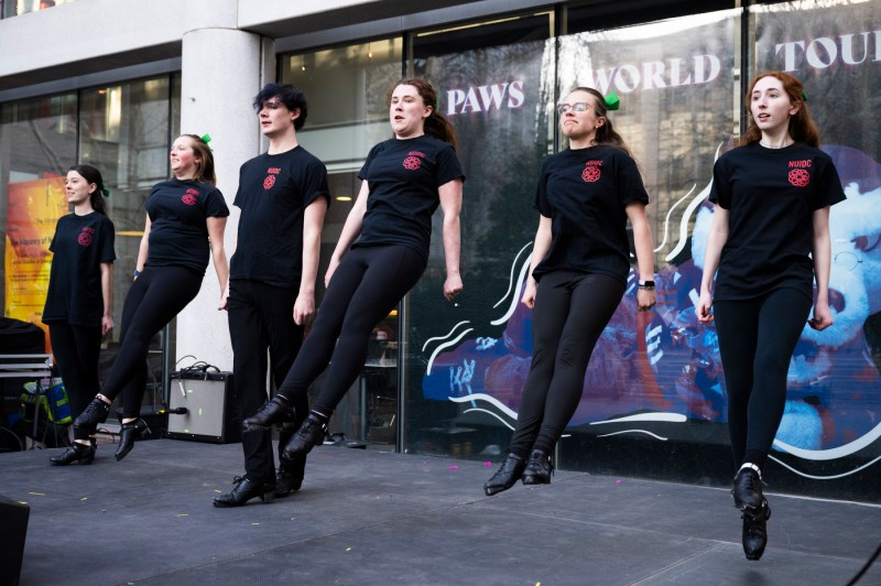 Irish dancers midair during their dance.