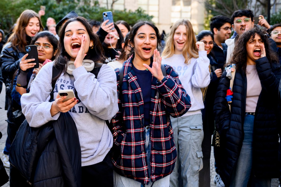 Audience members in a crowd outside cheering on the Paws World Tour.