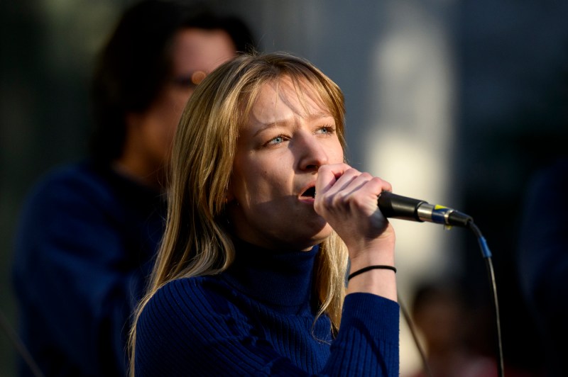 A person singing on stage at Paws World Tour.