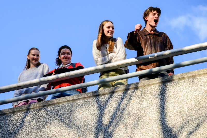 Audience members on the Curry roof deck look over and cheer on the Paws World Tour.