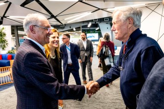 Senator Angus King shaking hands with another person.