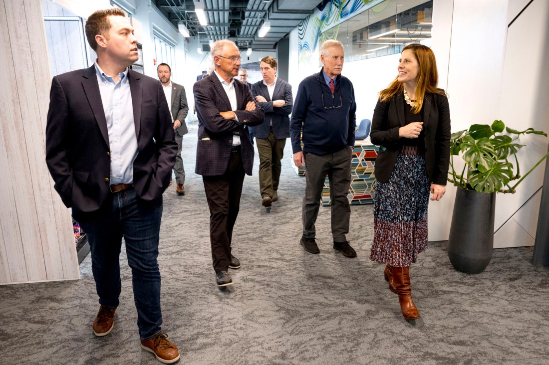 Senator Angus King walking around the Roux Institute with several other people.