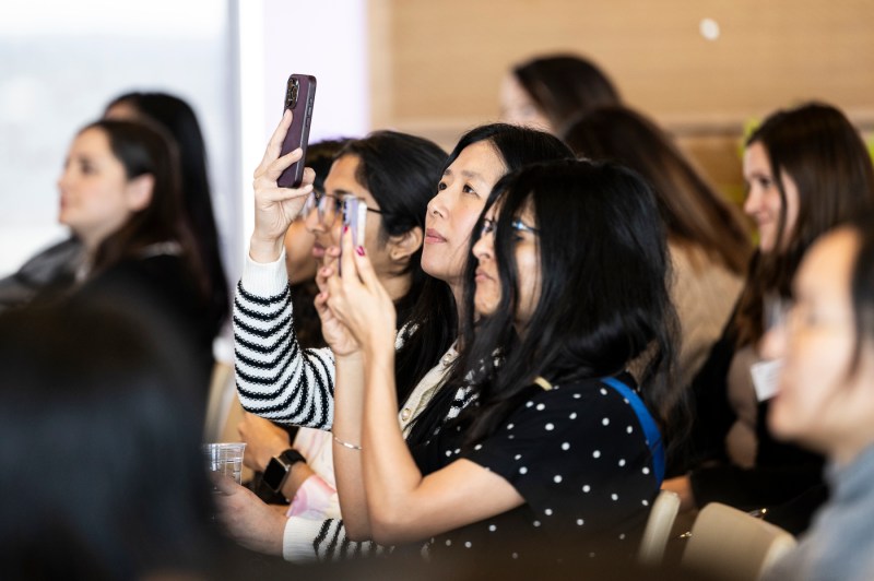 Audience members listening to Elise Hu speak at Women Who Empower event.