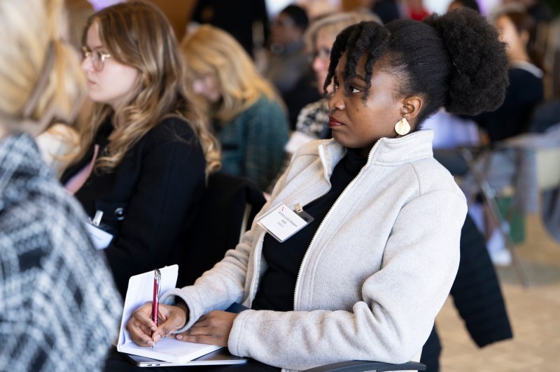 Audience members listening to Elise Hu speak at Women Who Empower event.