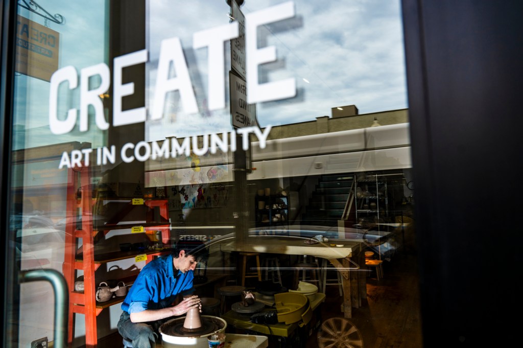 David Chatson throwing pottery on a wheel at the Create Art in Community studio.