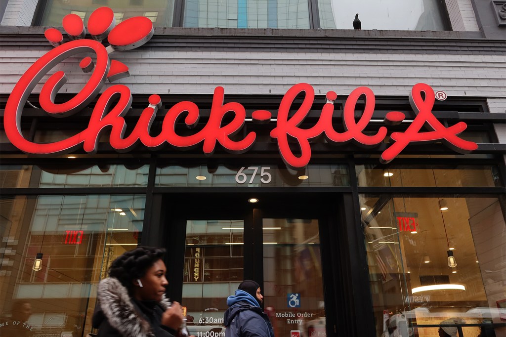 Exterior of a Chick-fil-A restaurant with the logo on the outside.