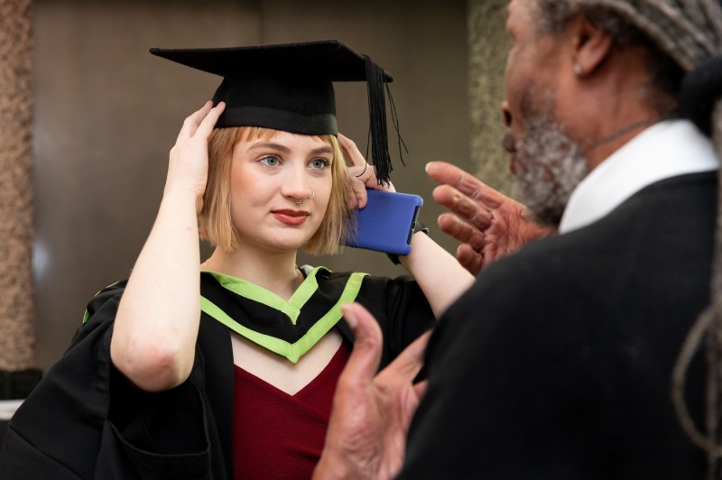 Student adjusting their cap.