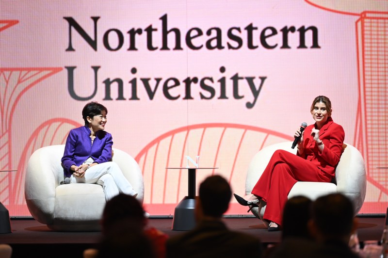 Two speakers sitting on white chairs at the Global Leadership Summit in Singapore. 