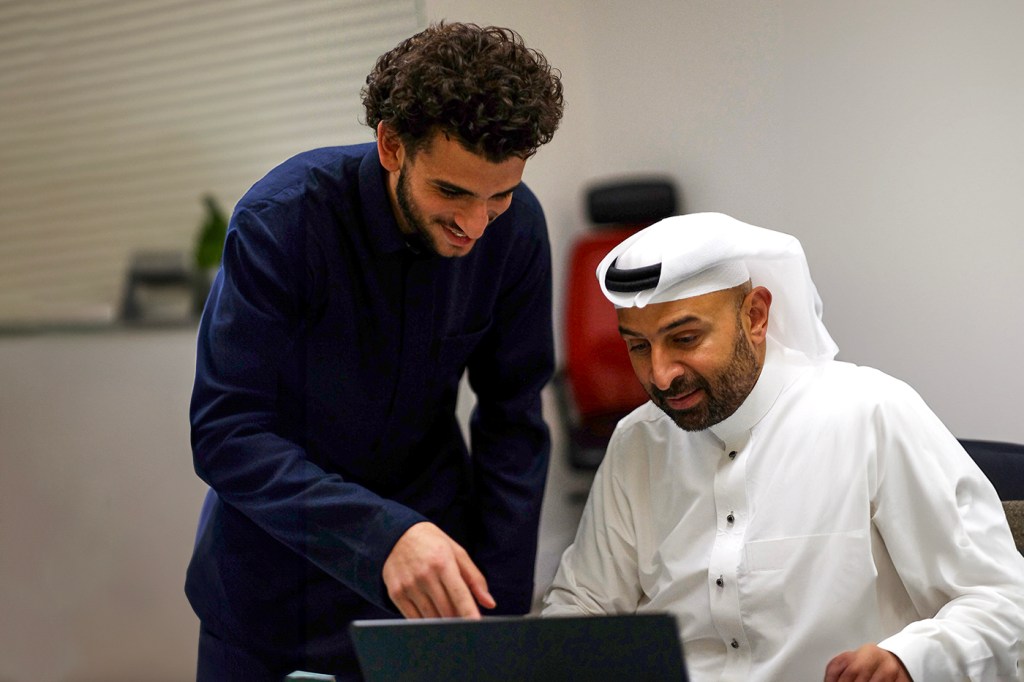 Yousif Elaidi working with another person.