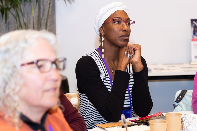 An audience member listening to a speaker. 