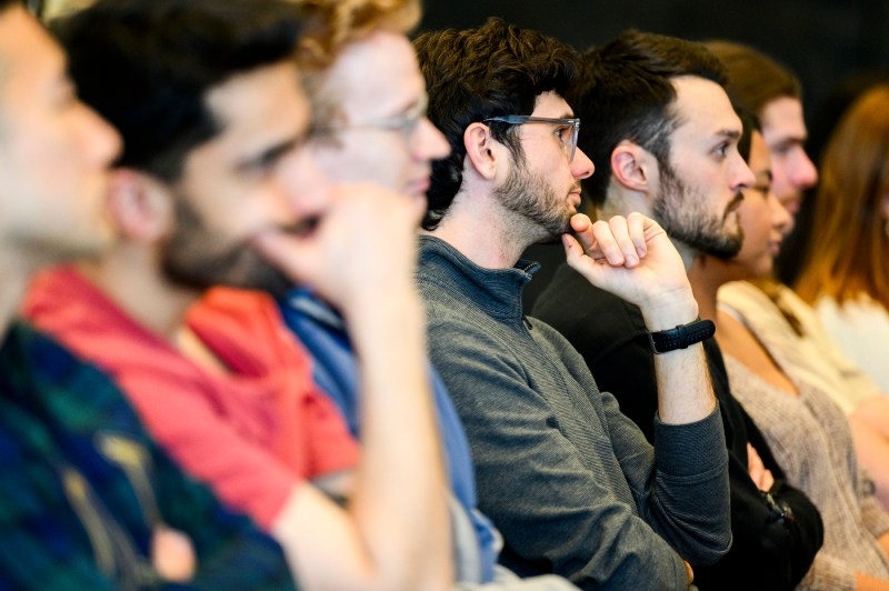 Audience members listening to the conversation between Francis Collins and Dave DeSteno.