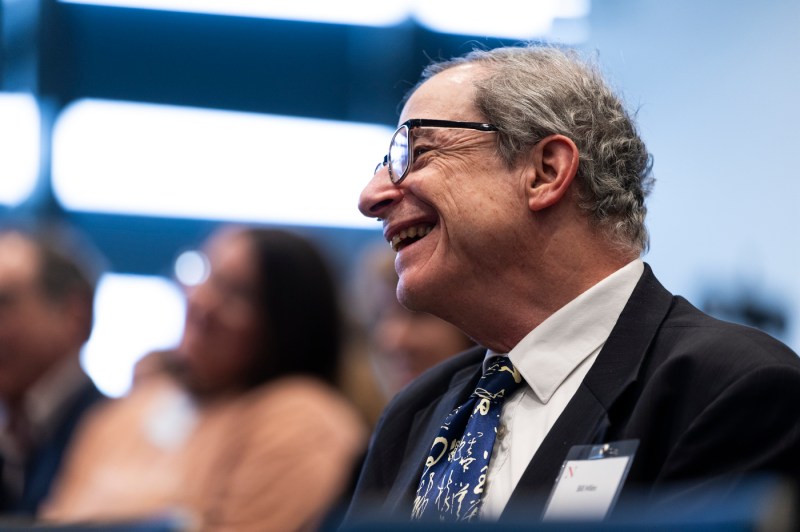 An attendee at the celebration laughs. 