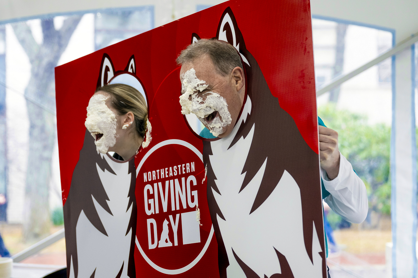 Two people with pie on their face.