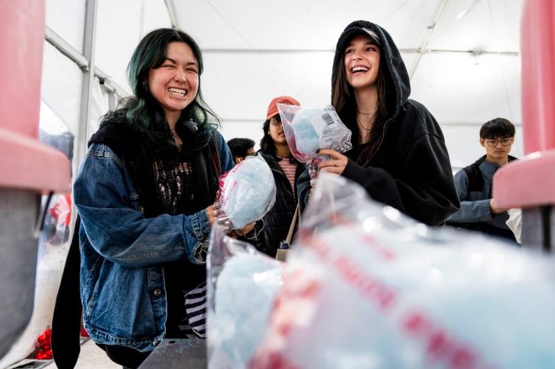 Two people holding blue cotton candy at Giving Day.