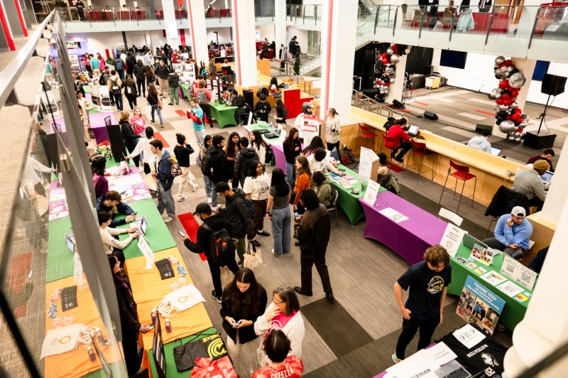 People walking around a room during Giving Day.