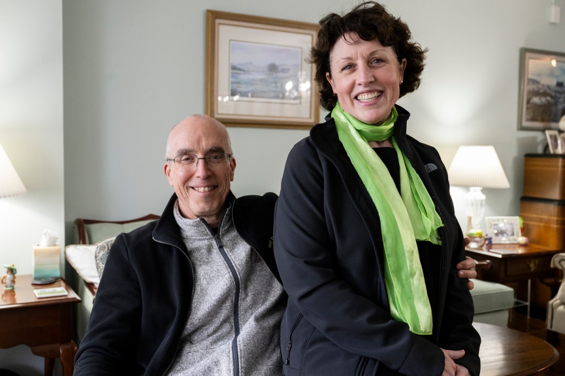 Cathleen and Thomas Griffin smiling in their home.