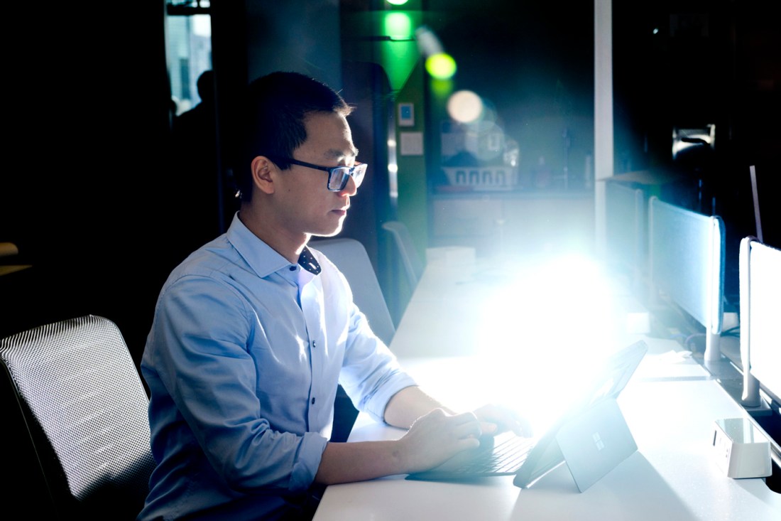 Ethan Wong working at a laptop. 