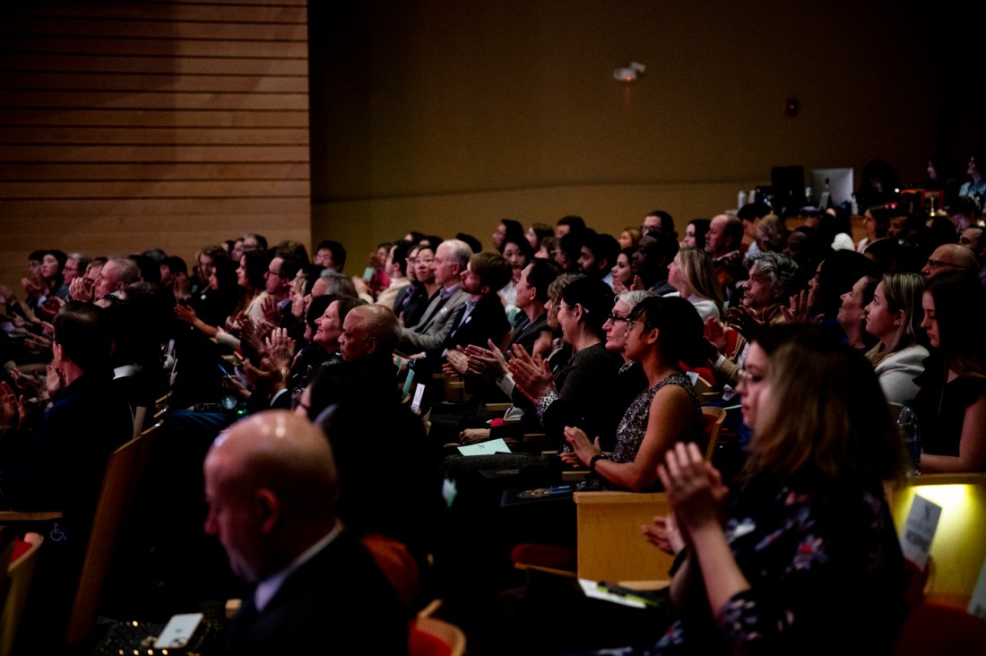 Audience members clapping at the Academic Honors Convocation in Blackman auditorium.