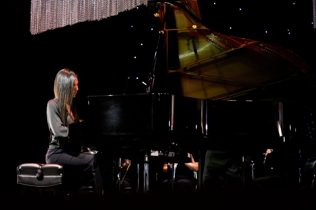 A person playing the piano in Blackman auditorium. 