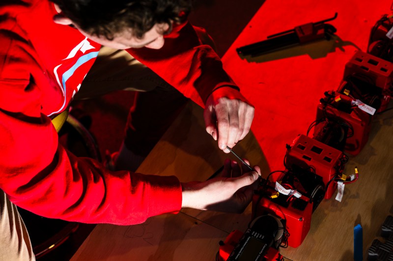 Henry Noyes working on the snake-like COBRA robot.