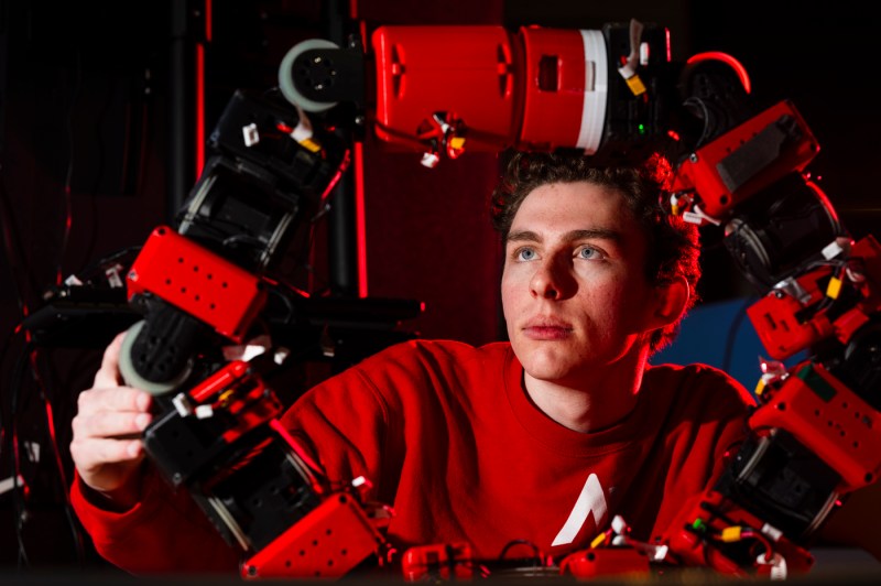 Henry Noyes working on the snake-like COBRA robot.