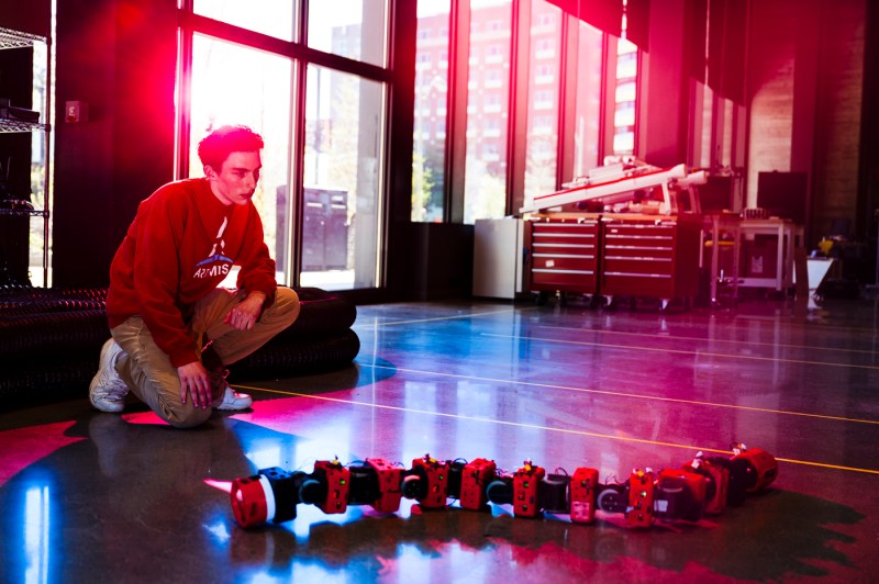 Henry Noyes working on the snake-like COBRA robot.