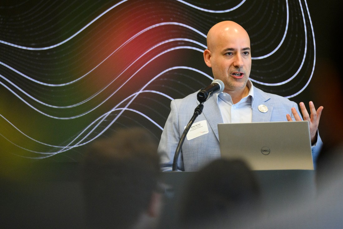 Matteo Rinaldi speakin into a microphone with a Dell laptop in front of him.