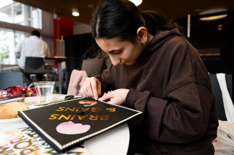 Student decorating their graduation cap.