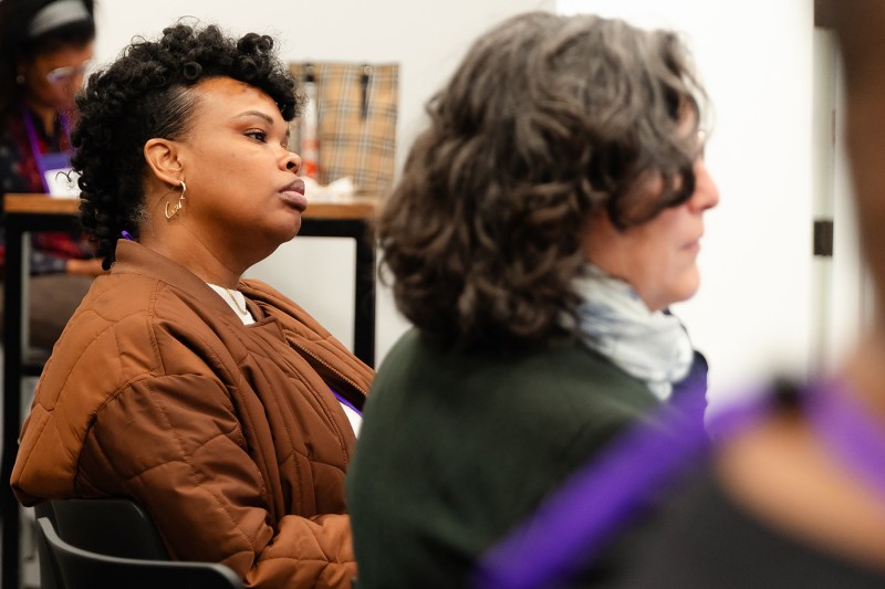 Two audience members listening. 